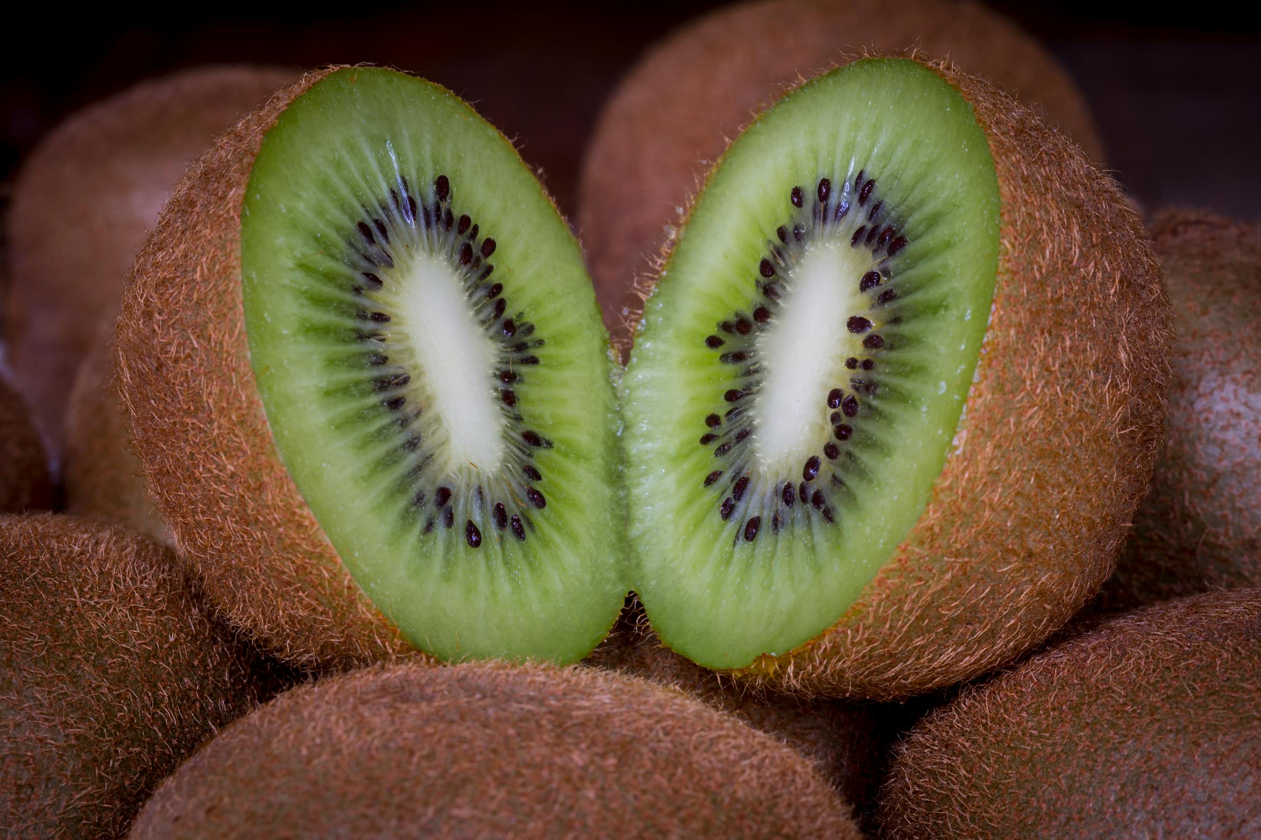 A vibrant close-up of a juicy, sliced kiwi showcasing its green texture and seeds.